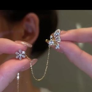 Butterfly at flower ear cuff with chain that threads through ear piercing
